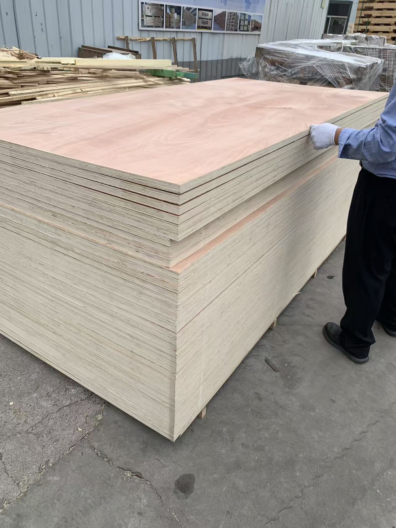Worker inspecting plywood quality at Rizhao Echon factory - ensuring material quality for custom crates